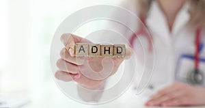 Doctor holding wooden blocks with ADHD inscription.