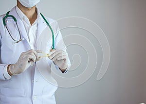 Doctor holding yellow umbilical cord clamp