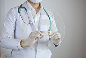 Doctor holding yellow umbilical cord clamp