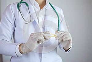 Doctor holding yellow umbilical cord clamp