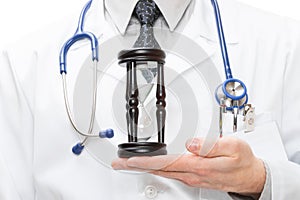 Doctor holdling in his hand a hourglass