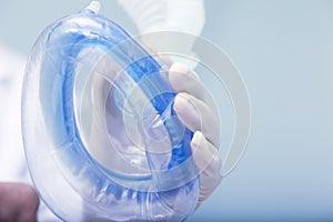 Doctor holds air breathing device on the patients face during pr