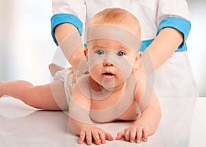 Doctor holds baby massage therapy