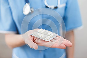 Doctor holds a blister with an antibiotic