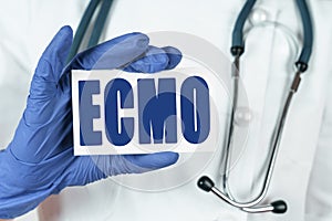 The doctor holds a business card that says - ECMO