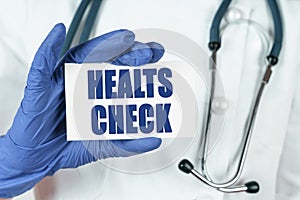 The doctor holds a business card that says - HEALTS CHECK