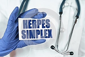 The doctor holds a business card that says - HERPES SIMPLEX