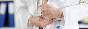 Doctor holds clipboard with the patient medical history