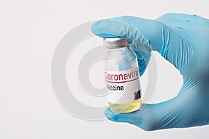 Doctor holds coronavirus vaccine before injection