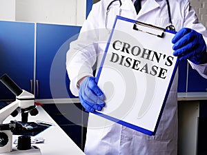 Doctor holds Crohn disease diagnosis photo