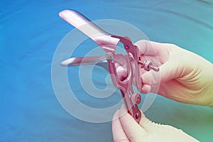 Doctor holds a disposable speculum photo