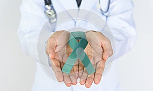 Doctor Holds green Ribbon