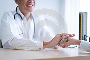 Doctor holds hands for patients to encourage