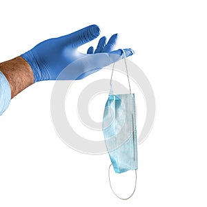 Doctor holds in his hand a protective disposable mask in a blue medical glove. Isolated a white background. The concept of the