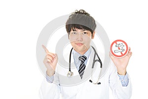 Doctor holds non smoking sign