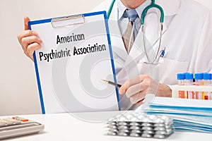 Doctor holds paper with inscription American Psychiatric Association