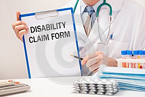 Doctor holds paper with inscription Disability Claim Form