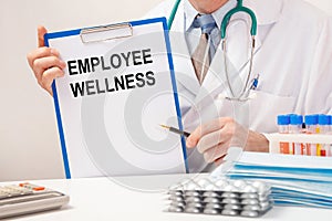 Doctor holds paper with inscription Employee Wellness