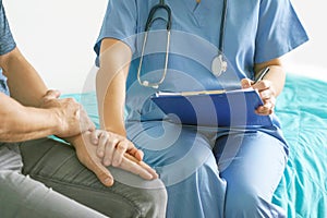 Doctor holds the patient`s hand