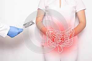 The doctor holds the results of the examination of the female patient on a white background. Bowel inflammation and disease photo