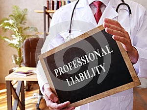 The doctor holds a sign with the Professional liability inscription.