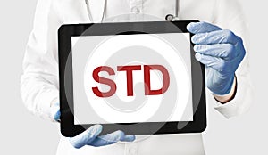 Doctor in holds a tablet with text STD