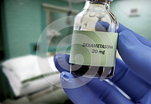 Doctor holds vial of dexamethasone in an operating theater photo