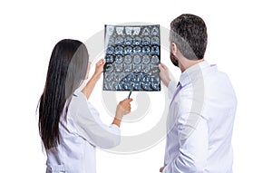 doctor in hospital looking at xray film healthcare, roentgen. medic in medical gown hold xray brain by radiographic