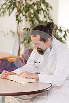 doctor in a hospital reads a book during lunch break