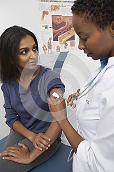 Doctor Injecting Indian Patient's Arm photo