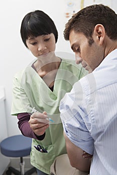 Doctor Injecting Patient photo