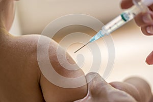 Doctor injecting a young child