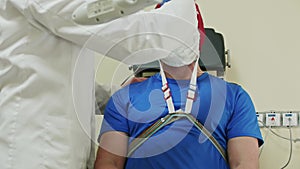 Doctor injects liquid into cap that a patient wears to start EEG. Procedure of neuro examination