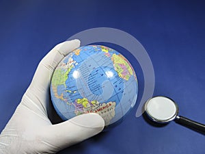 Doctor inspecting the globe with a stethoscope
