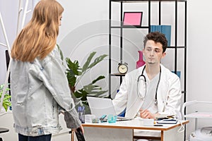 The doctor invites the patient to sit down and conducts an initial medical history about the illness. Doctor's office