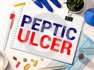 Doctor keeps a card with the name of the diagnosis -peptic ulcer. Selective focus