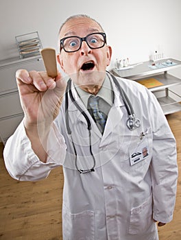 Doctor in lab coat using tongue depressor