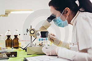 Doctor in the laboratory with a biological tube for analysis and sampling of Covid-19 infectious photo