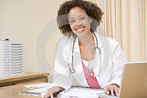 Doctor with laptop in doctor's office