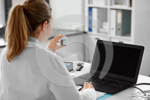 doctor with laptop having video call at hospital