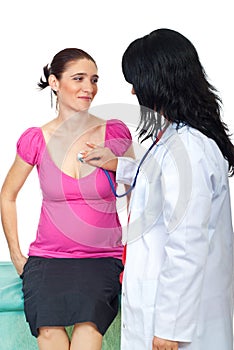 Doctor listen the heart of a pregnant woman