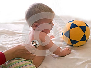 Doctor listening patient kid with stethoscope