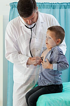 Doctor listening small patient lungs