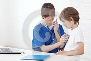 Doctor listening to child chest