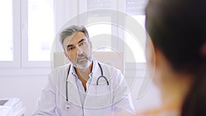 Doctor listening to a female patient in a clinic