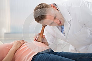 Doctor Listening To Heart Rate Of Fetus