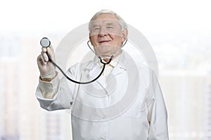 Doctor listening to heart with stethoscope.