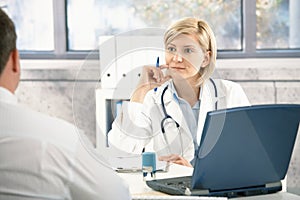 Doctor listening to patient