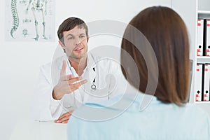 Doctor listening to patient with concentration at medical office