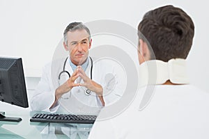 Doctor listening to patient with concentration in office